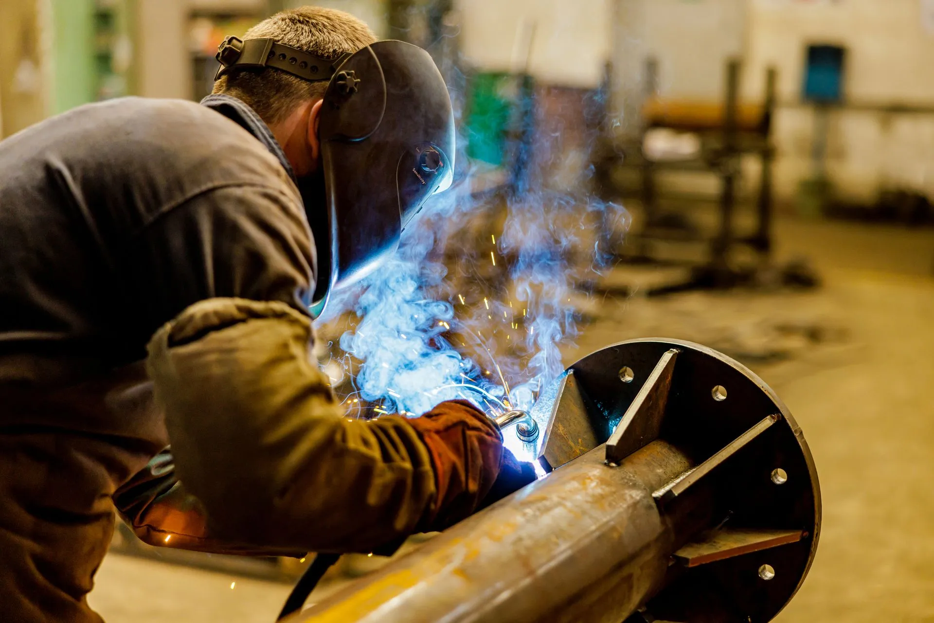 Worker welding metal parts